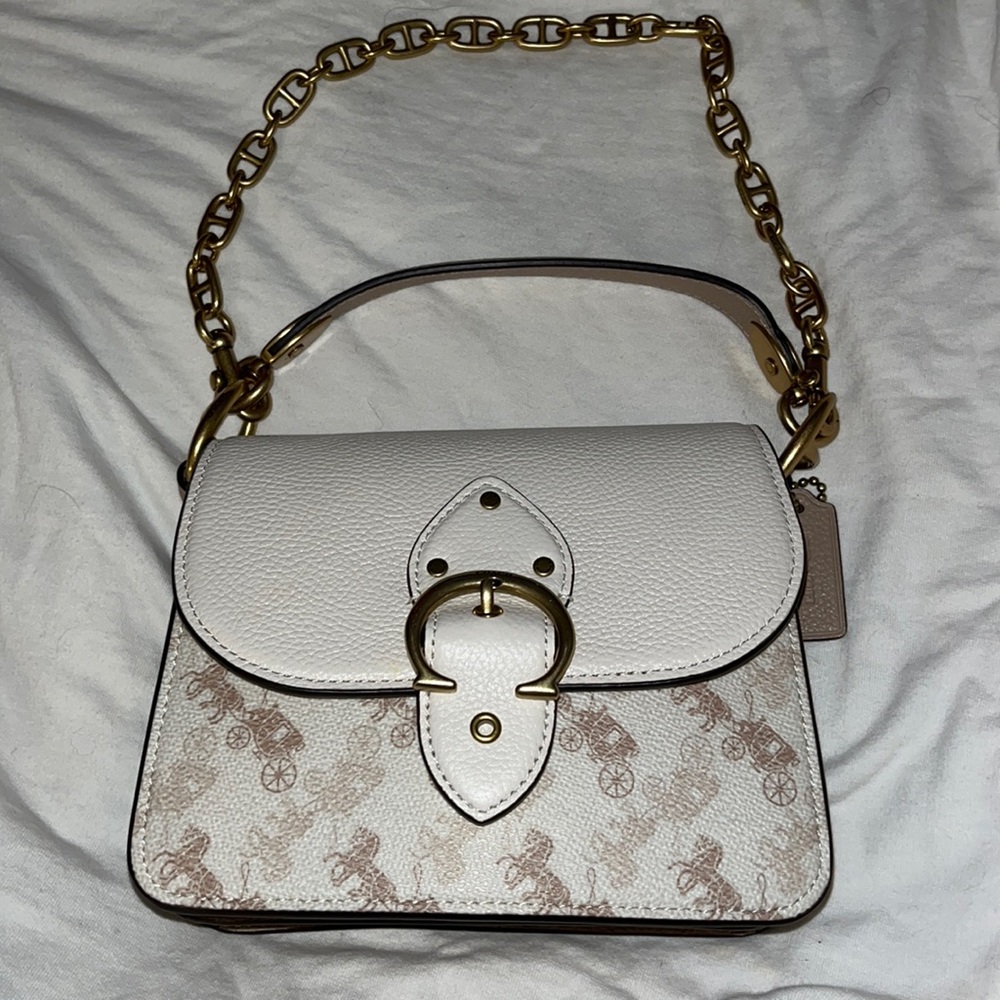 100% authentic. Beautiful white, tan, and cream colored Coach handbag.